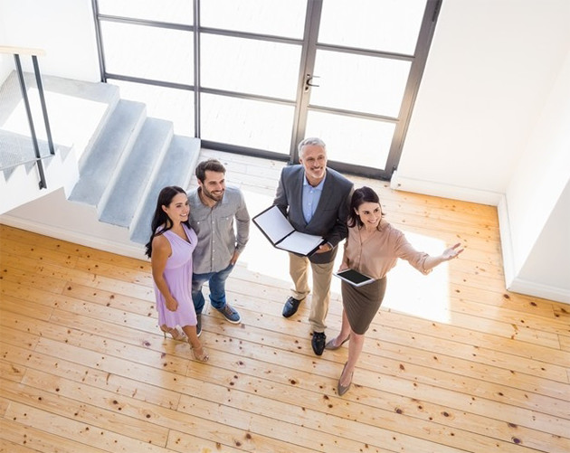 a couple being shown a house